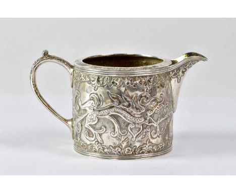 MARTIN HALL &amp; CO; a Victorian hallmarked silver milk jug, repoussé decorated with stylised Celtic dragon, height 6cm, She