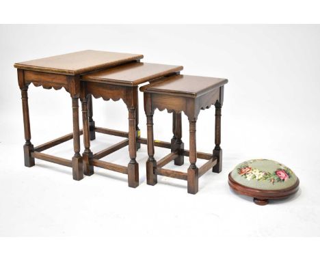 A reproduction nest of three oak tables in the manner of Titchmarsh &amp; Goodwin, largest 47 x 52 x 34cm, and a short footst