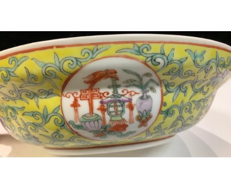 A Chinese ogee circular bowl, painted in polychrome enamels with roundels of precious objects, flowers and scrolling foliage 