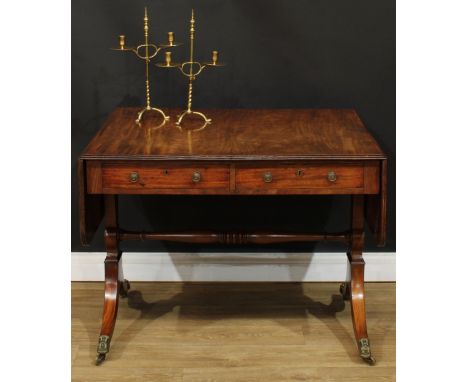 A Regency mahogany sofa table, rounded rectangular top with reeded edge and fall leaves above a pair of frieze drawers, blind