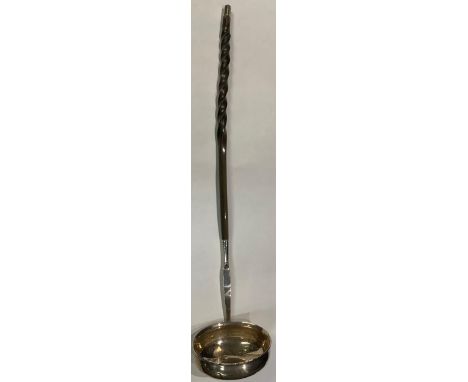 A Georgian silver toddy ladle, bearing a crest, baleen handle, 34cm long 