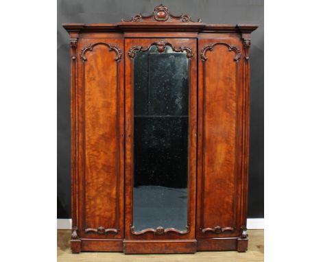 A Victorian mahogany breakfront wardrobe, by A. Blain, Liverpool, stamped, outswept cornice with shaped pediment carved with 