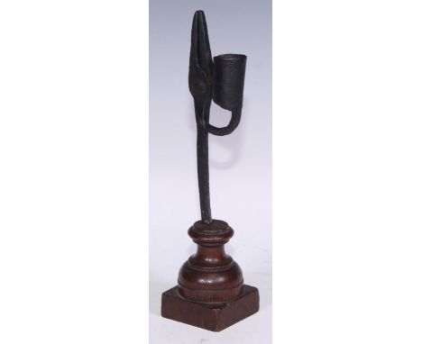 An 18th/19th century wrought iron nip rush light holder, turned oak base, 28cm high 