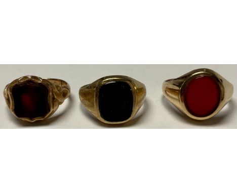 A Victorian 9ct rose gold shield shaped signet ring, set with a bloodstone, size Q, Birmingham 1865, 5.7g; a 9ct gold signet 