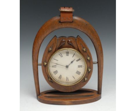An early 20th century oak novelty timepiece, of equestrian interest, the 9cm clock dial with horseshoe mount, set within a st