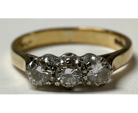 A 9ct gold three stone diamond ring, marked 375, size K, 2g