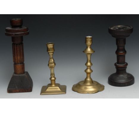 A George II brass petal base candlestick, of seamed construction, knopped stem, domed shaped circular base, 18cm high, c.1740