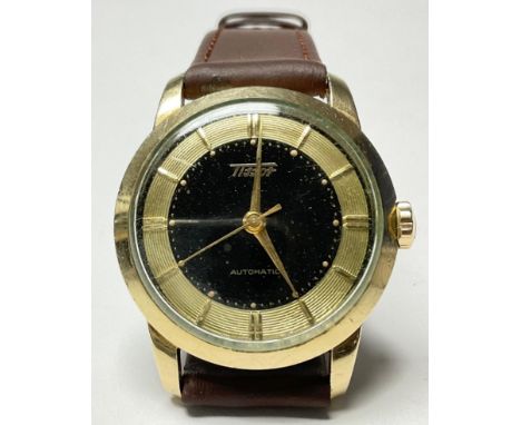 A Tissot automatic gentleman's wrist watch, black and gold dial, baton hour markers, leather strap 