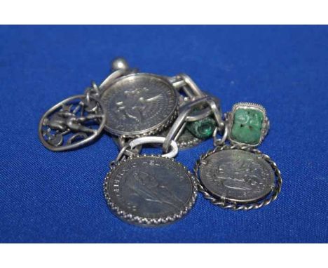 SILVER CHARM BRACELET
heavy chain links, mainly set with coin charms; together with a silver ring set with a small carved jad