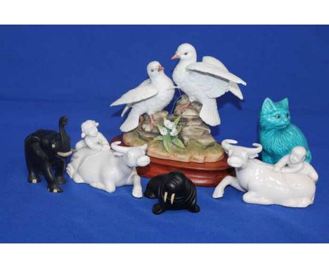 LOT OF ANIMAL FIGURES
including doves on a wooden stand, a blue ceramic cat, caved wooden elephant and walrus, and a pair of 
