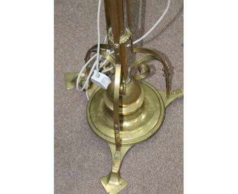 LATE 19TH/EARLY 20TH CENTURY EXTENDING BRASS STANDARD LAMP
converted for electricity, with scrolling strap work and on three 