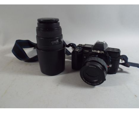 A Minolta 35mm Camera and Sigma Zoom Lens.