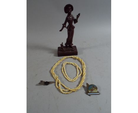 A Metal Figure of Maiden and Dog, Ivory Beads and Enamel Badges.