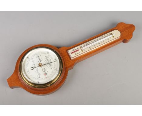 A vintage mahogany barometer with thermometer by "Short &amp; Mason London".