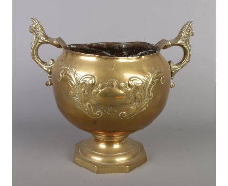 A vintage brass planter by William Soutter &amp; Sons Co, with two decorative handles and an octagon base, measuring H23 x W3