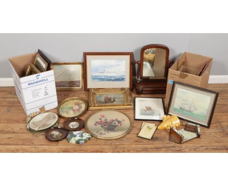 Two boxes of assorted mirrors and framed pictures, including examples of ship sailing scenes and floral artwork, along with a