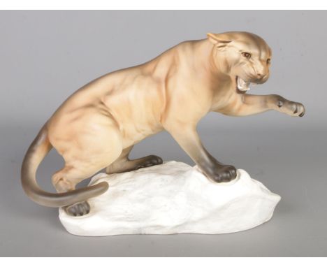 A Beswick ceramic figure of a Puma posed on rockface, matte edition number 1702. Approx. height 22cm.