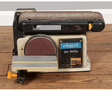 A Scheppach belt and disc sander with accessories and spare sanding sheets.