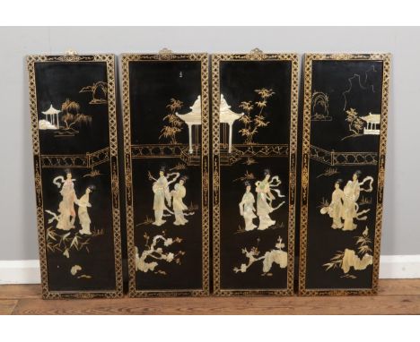 Four vintage Chinoiserie wooden wall plaques featuring lacquer panels adorned with Chinese figures and scenes. The relief det