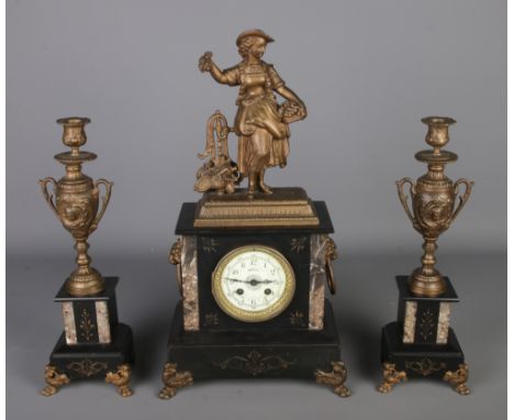 A 19th century French made mantle clock with spelter decoration to top with matching slate and marble garniture