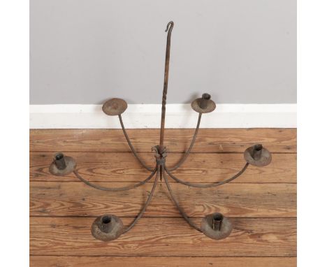 A wrought iron 6-candle chandelier, size H60 x W66cm.  Missing one candle holder.
