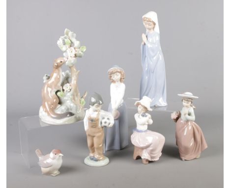 A collection of Lladro and Nao figures. Includes Lladro Ermine example.  Broken flower petal on Ermine figure.
