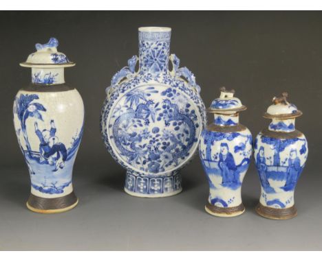 A Chinese blue and white moon flask, of traditional design decorated with dragons and trailing foliage, 30.5cm high, together