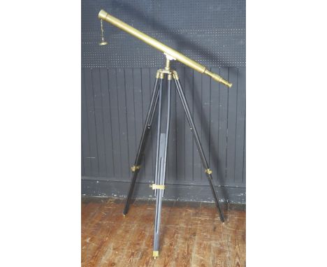 A brass 4cm refracting telescope, mounted on a brass and wood tripod, 98cm long.