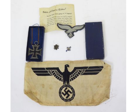 A World War II  German Iron Cross 2nd Class, a miniature Mothers Cross, a NSRL lapel badge, a Luftwaffe cloth badge and a Hee