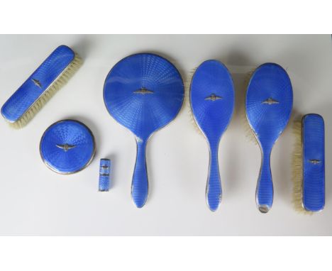 A matched silver and enamel dressing table set, various makers and dates, includes hair brushes, clothes brush, hand mirror, 