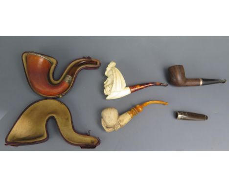A carved meerschaum and silver mounted smokers pipe, with amber mouthpiece contained in a fitted case, another in the form of