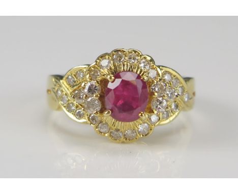 An 18ct Gold, Ruby and Diamond Cluster Ring, c. 5.9x5.1mm principal stone, size K.5, stamped 18K 750, 5g