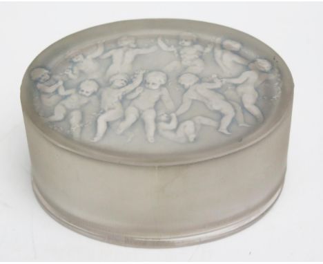 A Lalique glass Armours box of oval outline, the lift-off cover with light blue tint, decorated with dancing putti, moulded R