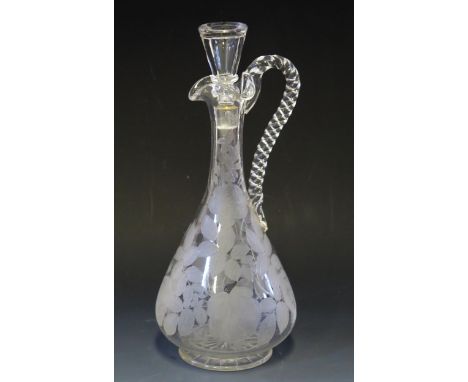 An etched glass wine ewer and stopper, with etched rose pattern decoration with spiral twist handle, 30cm high.