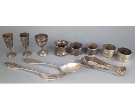 A mixed collection of French and other continental silver wares including napkin rings, egg cup, tot, sugar nips, fork, and s
