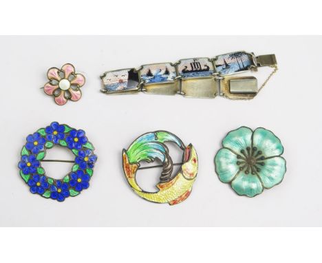 A Scandinavian Silver and Enamel Panel Brooch, two silver and enamel floral brooches, a silver and enamel leaping salmon broo