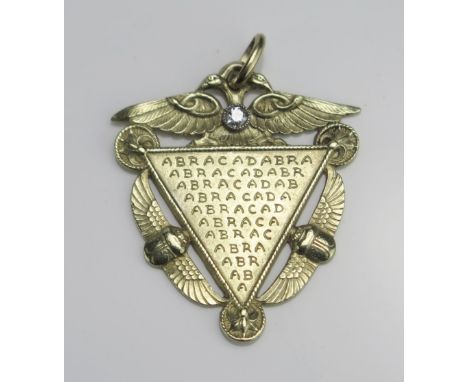 A French 18ct Gold "ABRACADABRA" Medallion decorated with a two headed bird to the top with a single old cut diamond to the n