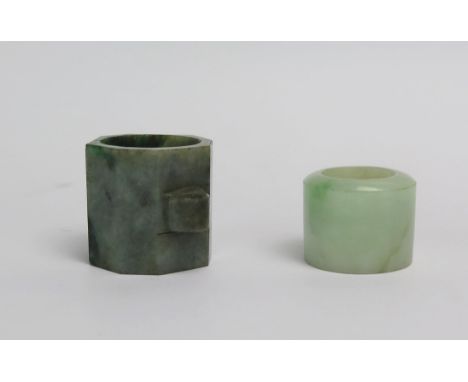 A polished pale jade archers ring of cylindrical form, 2.5cm high, an octagonal shaped archers ring, 3.25cm high. (2)