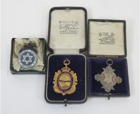 A 9ct gold and enamel medallion for The Catford Cycling Club, inscribed, 15.5gms, together with two other medallions.