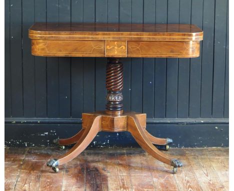 A Nineteenth Century Mahogany, Ebony and Boxwood Strung Fold Over Card Table on a spiral and palmette caved column an d raise