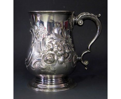 A Victorian silver mug, maker Robert Harper, London, 1872, with embossed floral decoration, with acanthus capped scroll handl