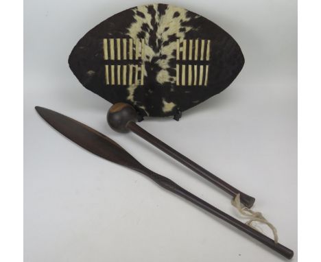 A South African knobkerrie, of traditional design, 55cm long, a small Zulu hide shield, 57cm long and a wood short spear.