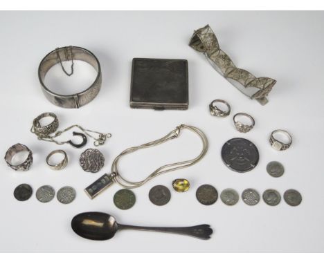 A mixed collection of silver wares including bracelet, powder compact, coffee spoon, rings coins etc.