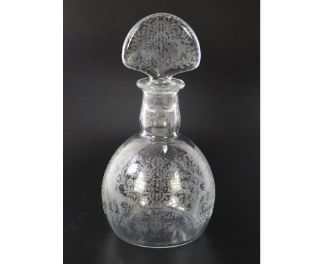 A Baccarat etched glass decanter and stopper, decorated with shaped cartouches amongst trailing foliage, 23cm high.