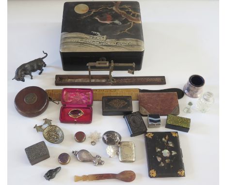 A Japanese lacquered box containing assorted collectables including, pinchbeck brooch, snuff boxes, folding sovereign scales,