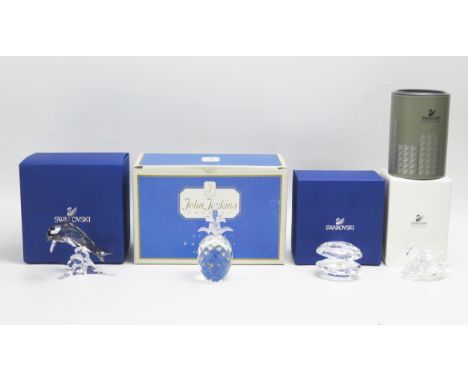 A Swarovski crystal model of a dolphin, 8cm high, a crystal pearl shell, 6.5cm wide, a swan 8cm long, all boxed and a crystal