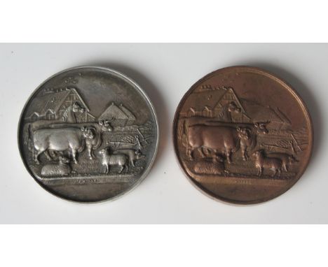 A Victorian white metal agricultural medallion, inscribed, 5cm diameter, 54gms, together with a bronze example.