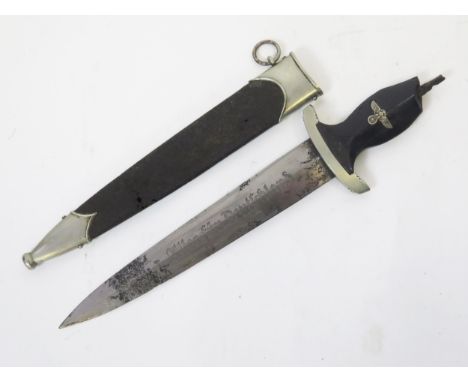 A Third Reich Period SS dagger, with 22cm etched double edged blade, damaged grip, contained in a metal scabbard.  WE DO NOT 