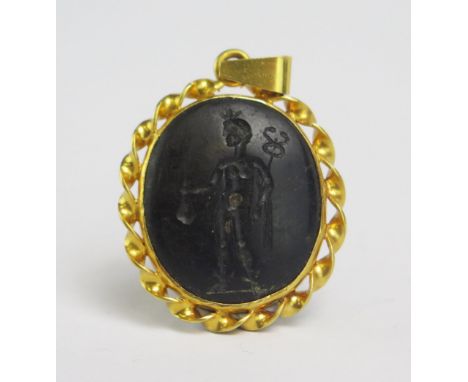 A Roman? Hardstone Intaglio decorated with a male standing figure representing Hermes with a caduceus and money bag and in a 