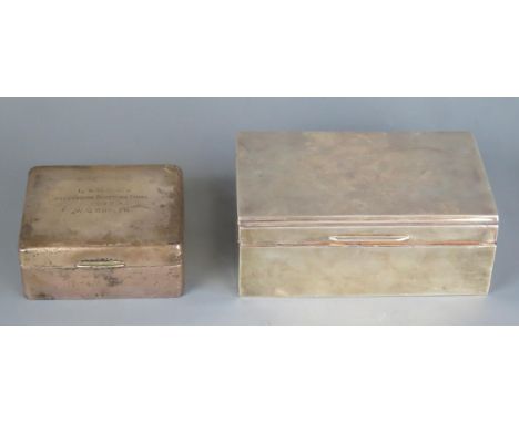 An Elizabeth II silver cigarette case, of rectangular outline, 13.5cm wide, together with a square example, 9cm wide, inscrib